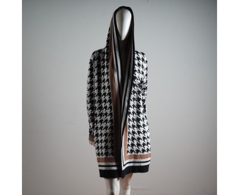 An eye-catching statement piece from the acclaimed Canadian designer Frank Lyman, this boldly patterned knit coat exudes both