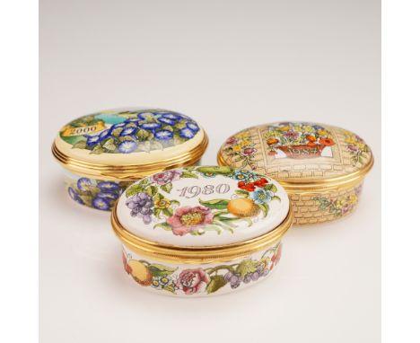 A group of three Halcyon Days and Bilston-Battersea enameled boxes, each commemorating a specific year. The 1980 example, dec