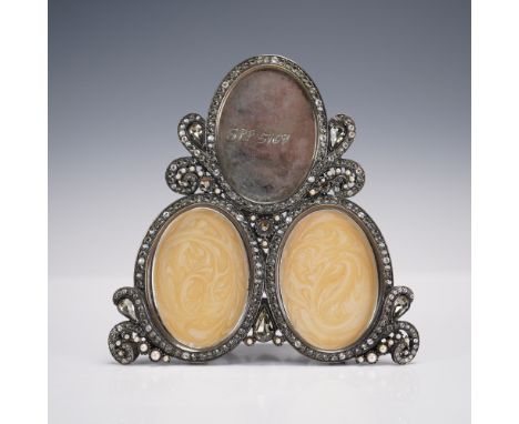 Triple portrait picture frame featuring an ornate triangular arrangement with three oval openings, each inset with creamy swi