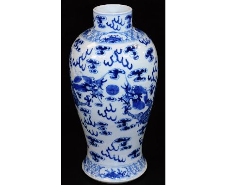 A 19thC Chinese blue and white porcelain baluster vase, decorated with four clawed dragons chasing the flaming pearl among cl