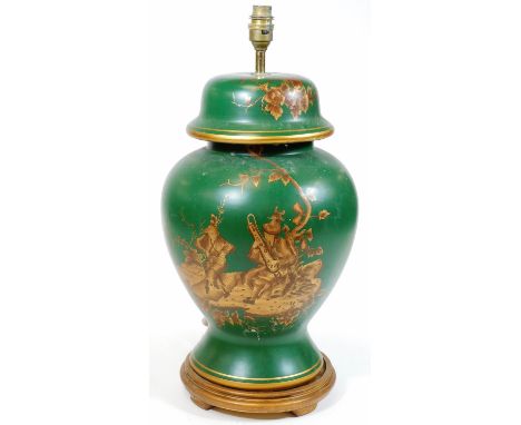 An oriental design lamp vase, in green with gilt highlights, decorated with figures, flowers and leaf heads on a circular bas