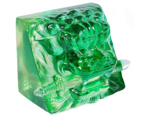 A jade coloured glass sculpture paperweight, of a lion's head with sword to the mouth, possibly Sri Lankan, 12cm W. Provenanc