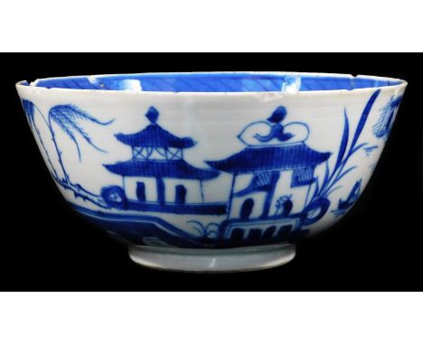 A 19thC Chinese blue and white bowl, profusely decorated with buildings, figures and tress, on a circular foot, the interior 