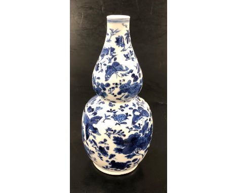 A Chinese blue and white double gourd porcelain vase, decorated with butterflies, birds and fauna, four character Kangxi mark