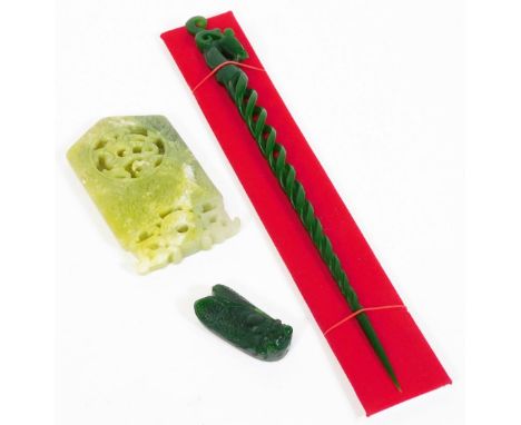 Three oriental green jade carvings, a spirally carved pin with dragon head, a insect and a pale green variegated slab carved 