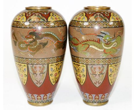 A fine pair of Meiji period Japanese cloisonne enamel vases, decorated with bands of four clawed dragons and shield panels of