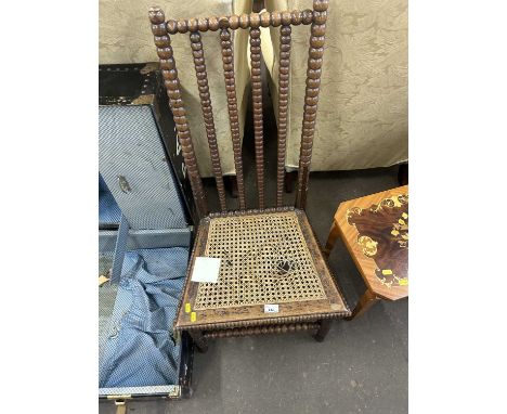 A Victorian cane seated chair with bobbin turned frame