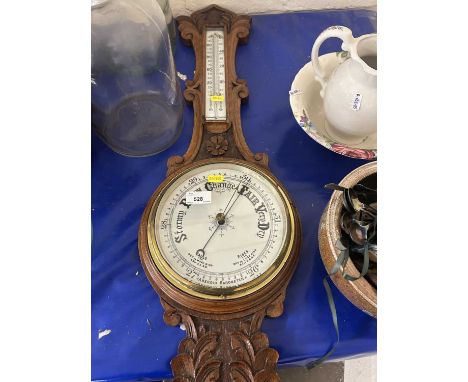 An early 20th Century oak barometer and thermometer combination