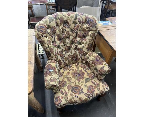 A floral upholstered button back armchair