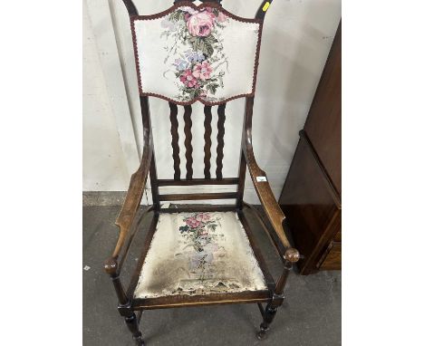A late 19th Century floral upholstered and hardwood framed armchair bearing label for Hewetson, Milner &amp; Threxton, Totten