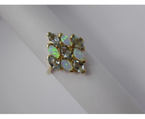 A Lady's 9ct Yellow Gold blue Topaz and Opal  Ring, topaz 5 x 2.6 mm, size O, approx 3.3  gms.