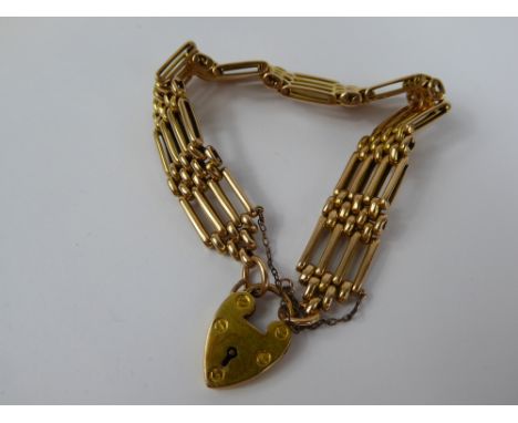 A Lady's 15 ct Gold Four Bar Gate Link Bracelet, with heart shape clasp, approx 27.8 gms.
