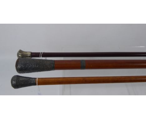 A 19th Century Swagger Stick, with decorative white metal top, together with vintage walking sticks. (3) (af)