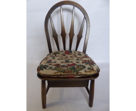 An Ercol Nursery Chair, with a single drawer beneath.