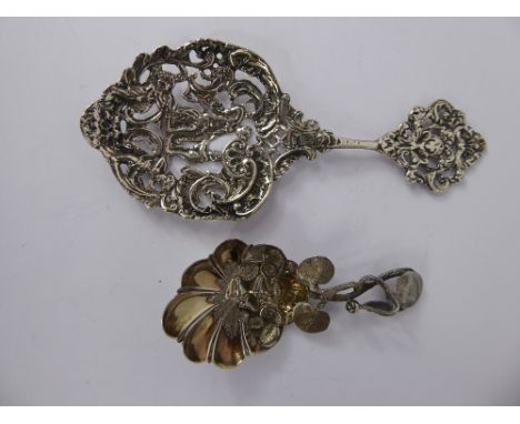 A Victorian Silver Decorative Spoon, with pierced bowl depicting cherubs together with a white metal caddy spoon with lilly p