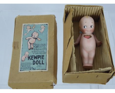 A Vintage KEWPIE Porcelain Doll, in original box.