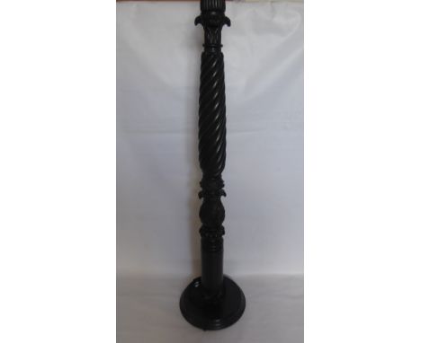 An Ebonised Carved Lamp Stand, with ribbon turned column, carved laurel base, approx 160 cms high.