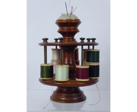 A Wood Turned Cotton Reel Holder, with fitted pin cushion finial, holds approx sixteen spools.