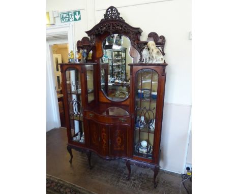 An Ornate Late Victorian Inlaid Display Cabinet, circa 1900, having glazed doors to either side with shelved interior, decora