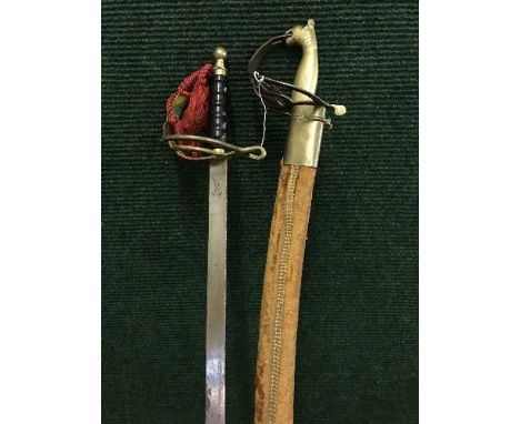 A Indian sabre in scabbard, with another sword 