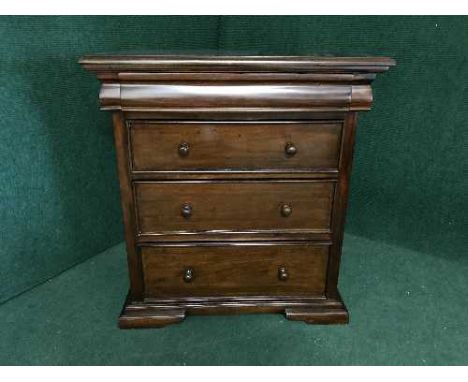 A mahogany four drawer chest on bracket feet