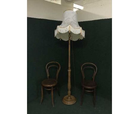 A pair of Bentwood chairs together with a standard lamp and shade