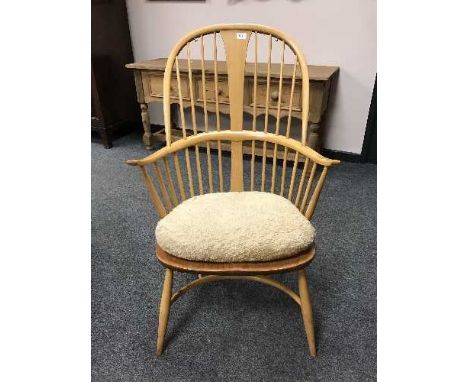 An Ercol light elm spindle backed Windsor style armchair