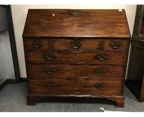 A George III mahogany bureau on bracket feet