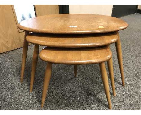 A nest of three Ercol elm pebble tables