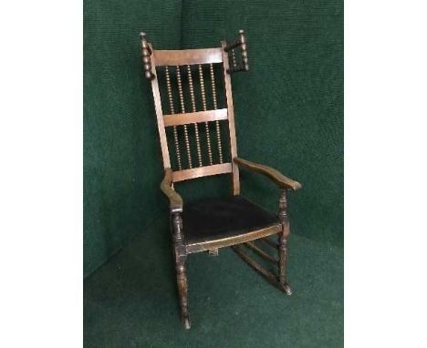 A late nineteenth century bobbin wing rocking chair
