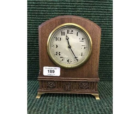 A mahogany mantel clock on brass bracket feet 
