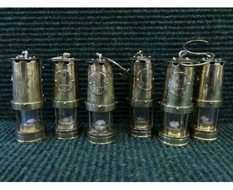 Set of six miniature brass miner's lamp bearing City of Durham label 