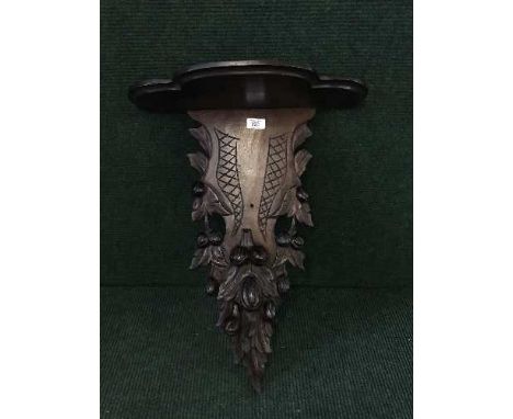 A late 19th century heavily carved mahogany wall bracket 