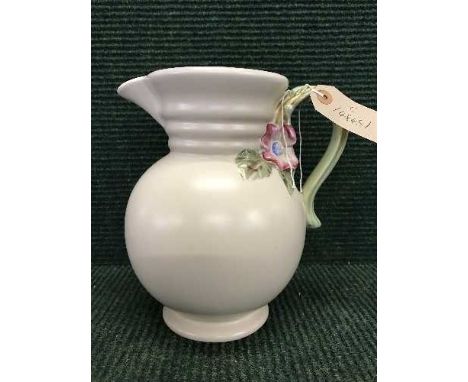 A Clarice Cliff beige pottery jug with floral handle
