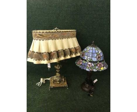 A decorative gilt metal table lamp on marble base and Tiffany style lamp 