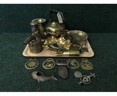 A box of horse buckles with examples by J.M. Cather & Sons, badges, brass blow torch, kettle, oil lamp etc 
