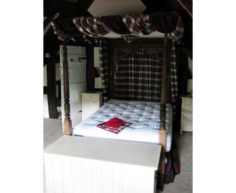 An antique oak tester bed, the rectangular headboard with arched panel, floral and Chippendale carving, spiral turned ends, m