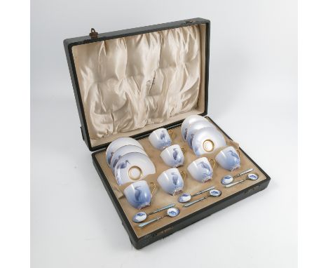 A boxed Royal Worcester coffee set, the six coffee cups and saucers decorated with blue/grey storks to a blue ground, dated 1