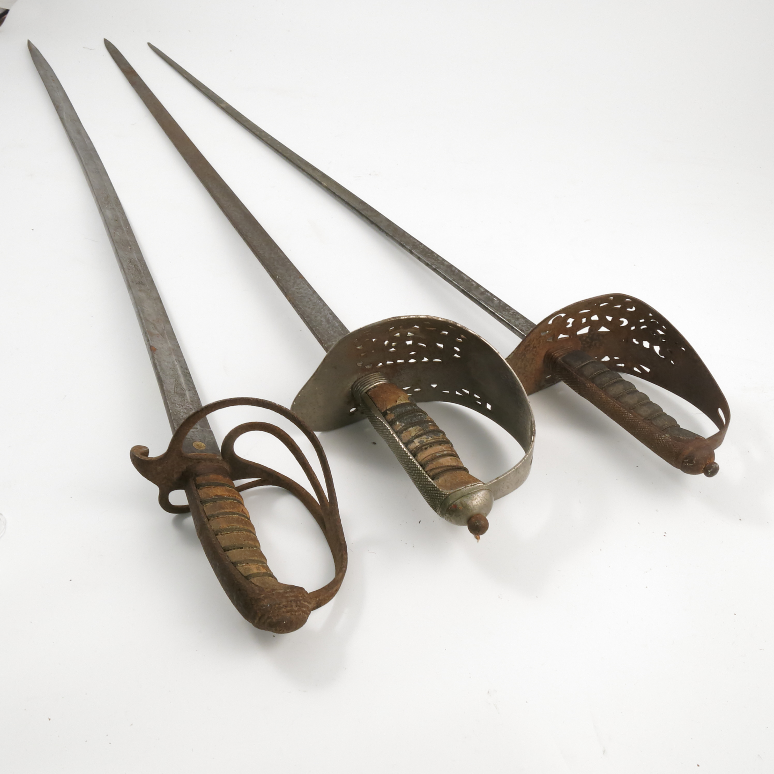 Three 19th century cavalry swords, one with wire basket hilt marked Brown & Co London, a Wilkinso