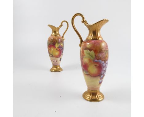 A pair of ERB Worcester ewers, decorated all around with fruit to a mossy background by C R Bacth, with gilded neck, handle a
