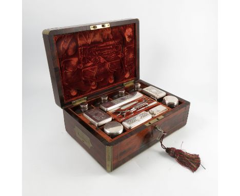 A late Georgian Rosewood brass bound fitted travelling case, with interior fitted with silver topped glass bottles and jars, 