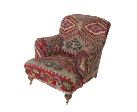 An armchair, upholstered in the Kilim style