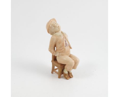 A Royal Worcester blush ivory figure, of a boy in Victorian dress asleep seated on a chair with his hands in his pockets, dat