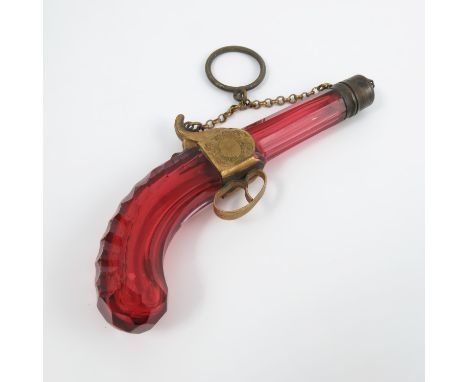 A 19th century ruby glass scent bottle, modelled as a pistol, with glass barrel and stock with gilt metal mounts and finger s