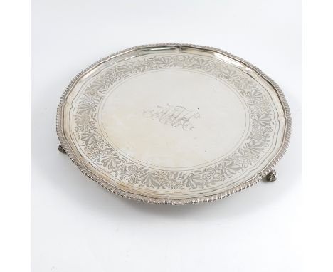 A Georgian silver salver, with shaped gadrooned edge, the centre engraved with initials to a strawberry and leaf border, Lond