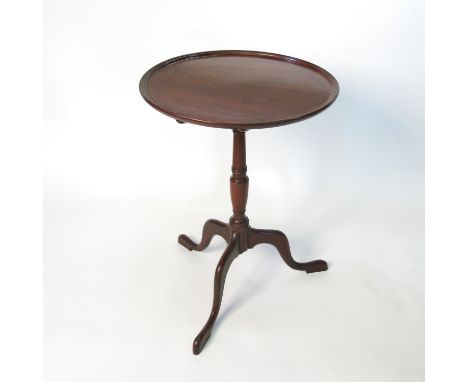 A 19th century mahogany tripod table, the single piece circular top raised on a turned column with three outswept supports, d