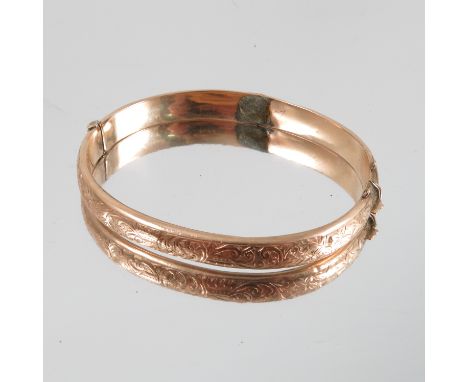 A 9 carat gold half engraved hinged bangle, weight 8.7g gross