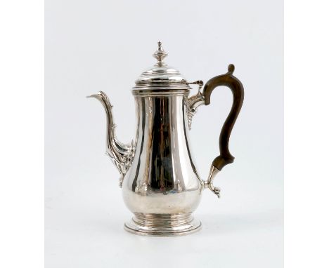 A silver coffee pot, with stepped cover and baluster body, with leaf and scroll decoration to the spout, Sheffield 1928, make