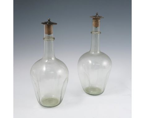 A pair of James Powell Whitefriars dimple glass decanters, with ribbed glass ring to the neck, the silver stoppers with Arts 