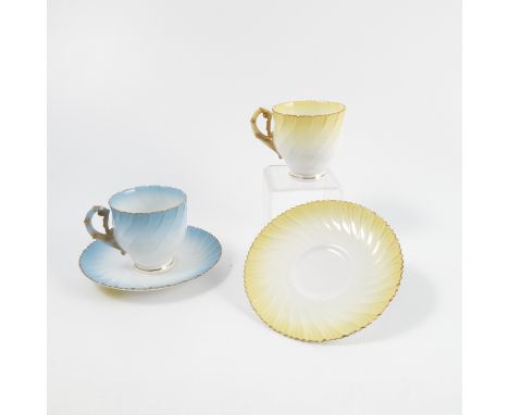 Two Royal Worcester tea cups and saucers, the shaped body decorated in either yellow or blue, dated approximately 1890   Cond